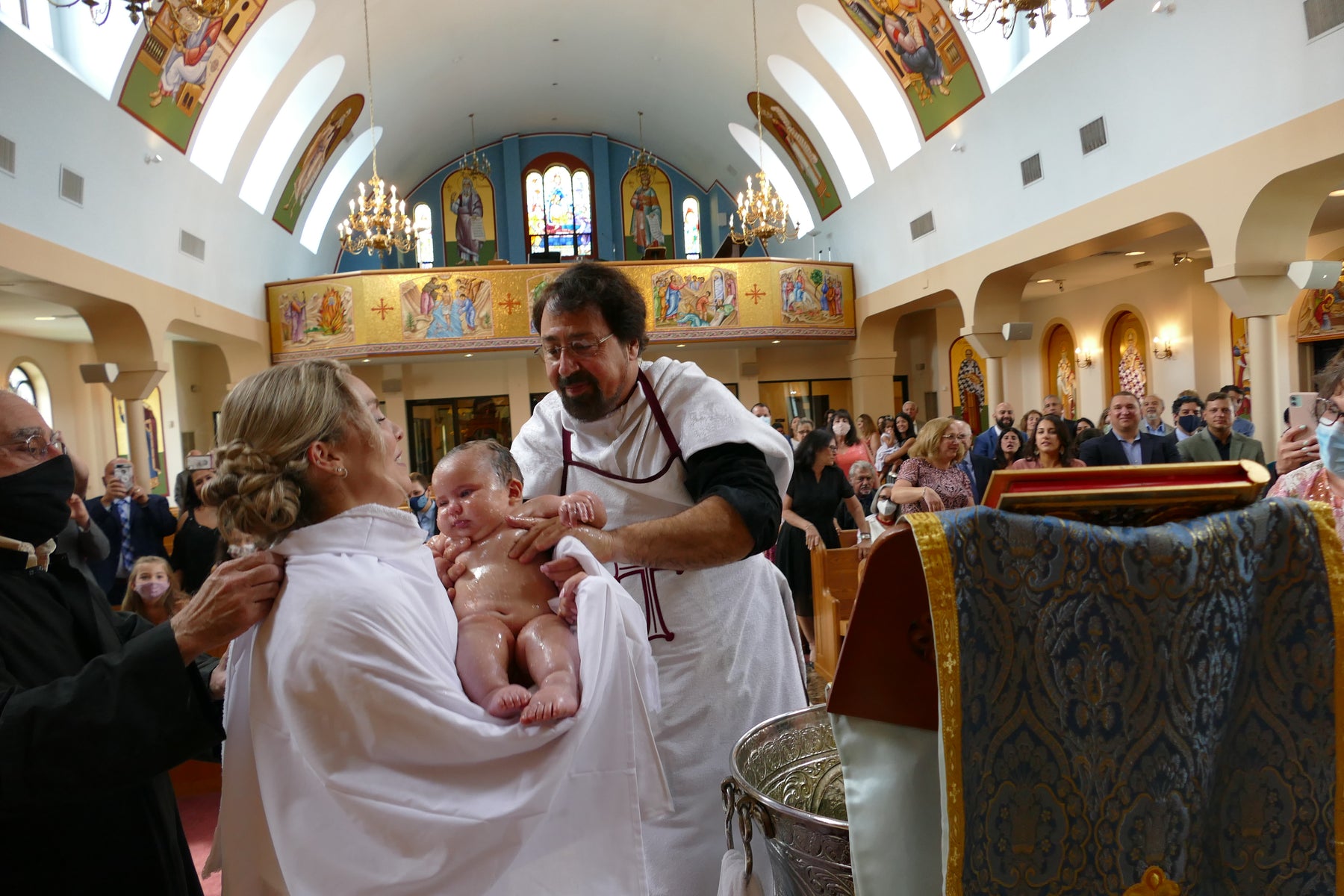 Baby being Baptized in Greek Orthodox Service.